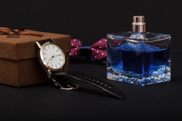 brown-gift-box-watch-with-black-leather-strap-bow-tie-perfumes-men-black-background-accessories-men_393202-7232