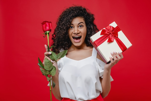 happy-smiling-black-girl-with-rose-gift-box-isolated-red_97712-3254 (1)