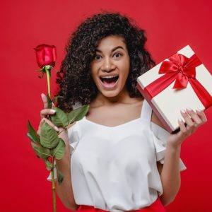 happy-smiling-black-girl-with-rose-gift-box-isolated-red_97712-3254 (1)